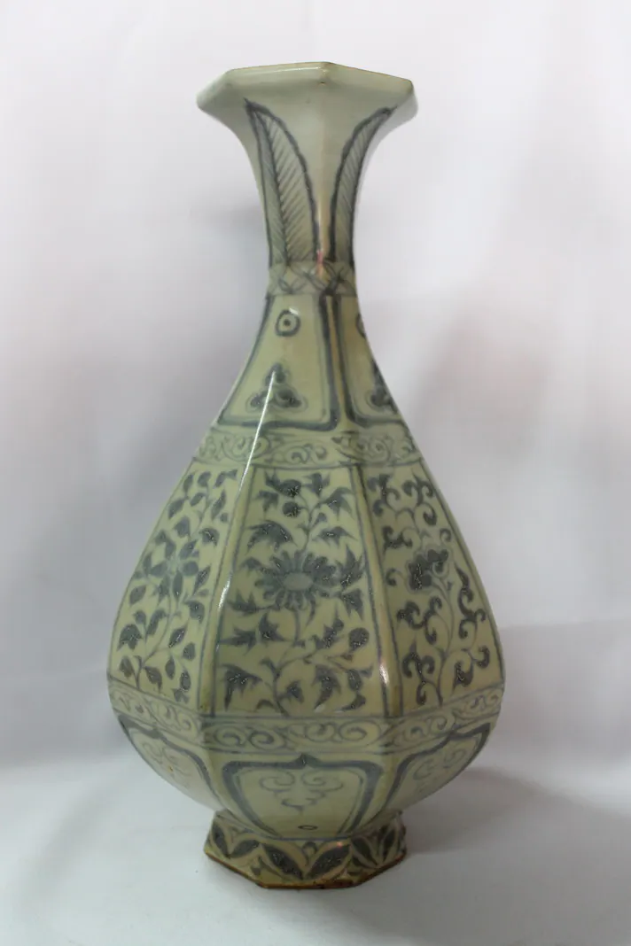 Blue and white octagonal pear-shaped vase, front view, with a flared neck and floral panels