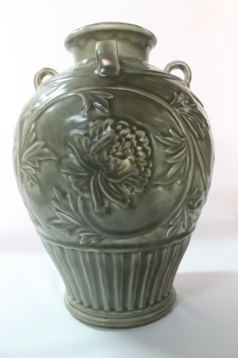 Close-up of the carved peony medallion on the vase's shoulder