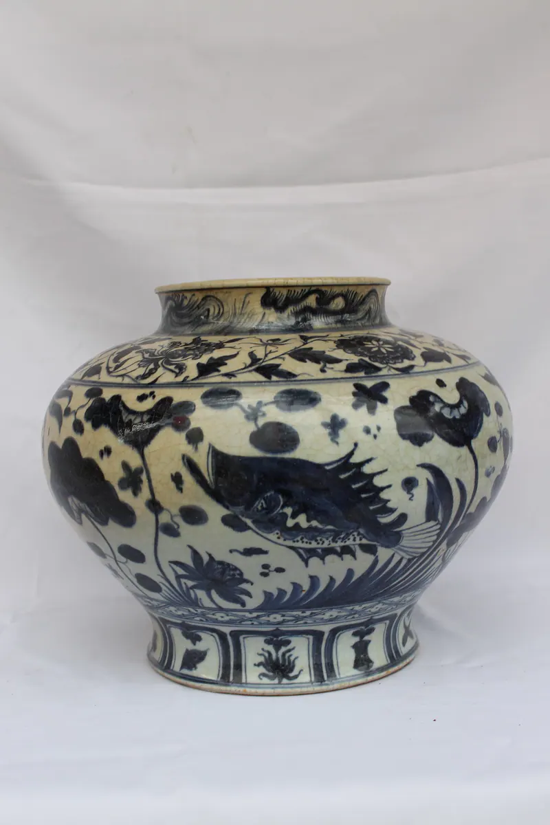 Blue and white porcelain jar, front view, with a large fish in an underglaze pond scene