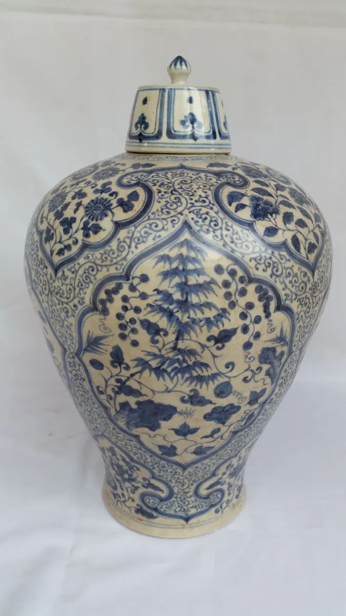 Front view of the covered meiping vase with a pointed knob finial and blue underglaze tree panel