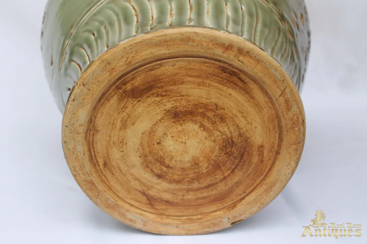 Base of the celadon vase showing the unglazed foot with no stand mark, just concentric throwing rings