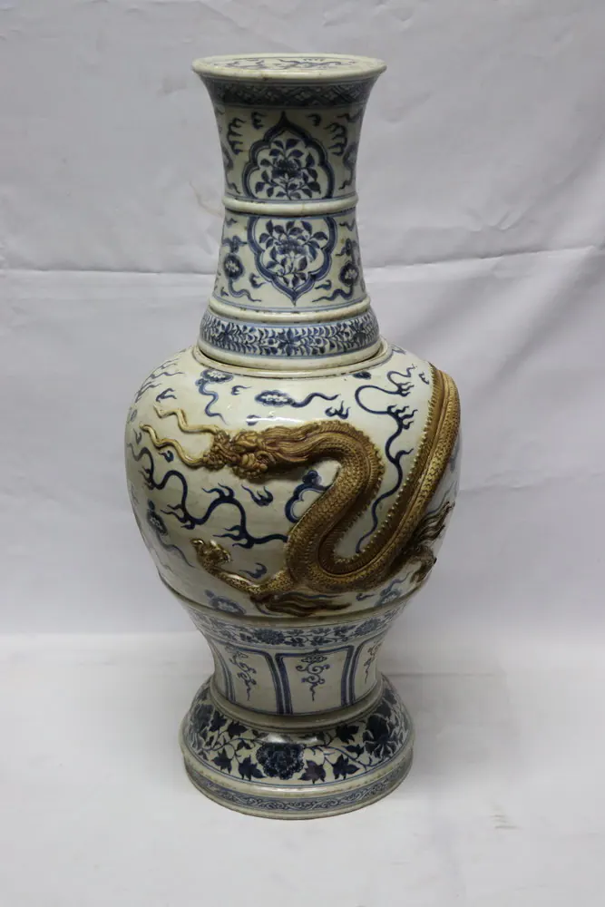 Front view of the vase with an applied gilt-toned dragon in relief coiling around the cloud-scroll body