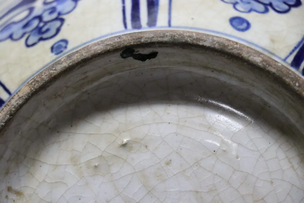 Extreme close-up of the base rim showing a dark kiln spot within the crackled glaze