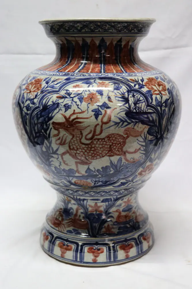 Front view of the vase showing a qilin with flaming mane among foliage in red and blue