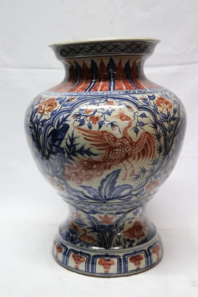 Front view of the vase in red, blue, and cream, with a phoenix among peonies on the body