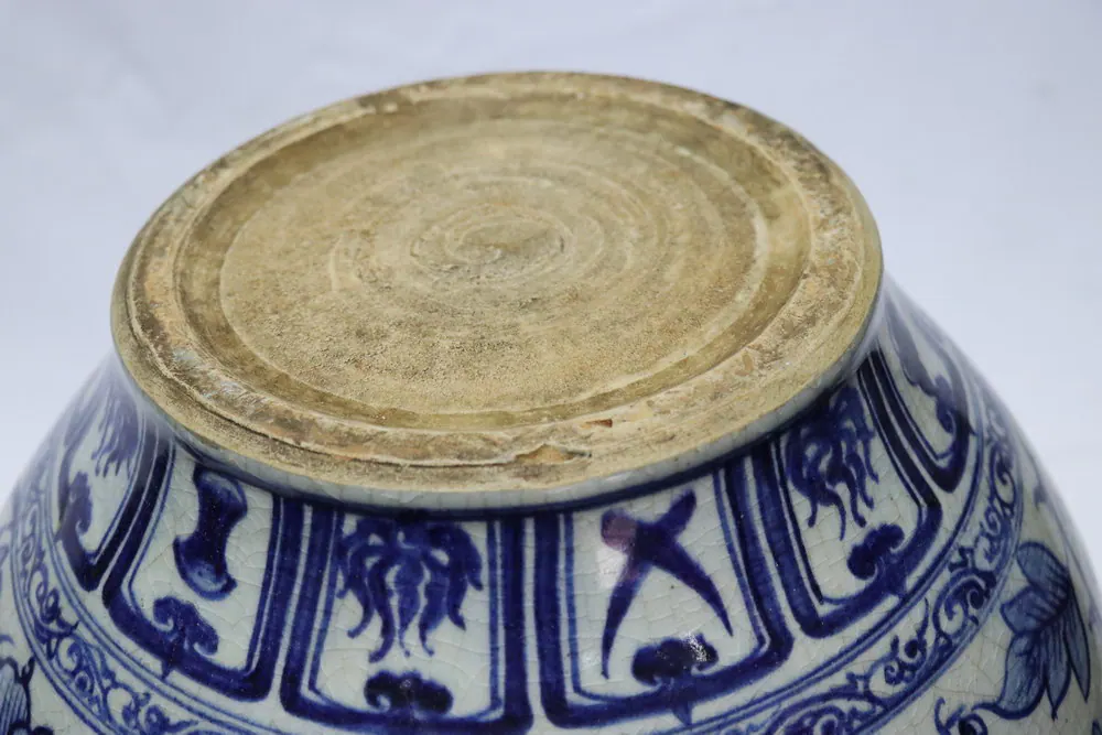 Unglazed base of the vase turned upside down, showing concentric throwing rings and no visible mark