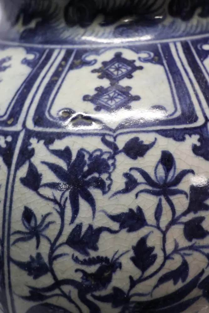 Close-up of the shoulder join showing diamond lozenge panels above a floral scroll band