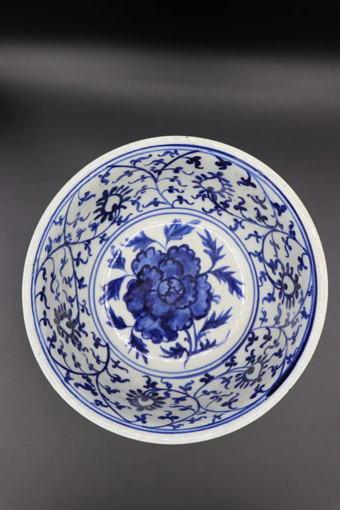 Overhead view of the bowl showing a central peony medallion within a scrolling floral border