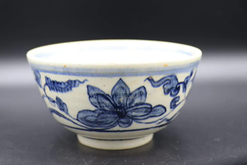 Close side view of the exterior lotus scroll with a large blossom and curling leaves
