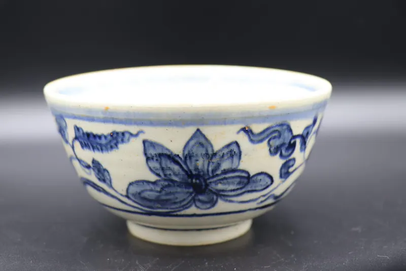 Close side view of the exterior lotus scroll with a large blossom and curling leaves