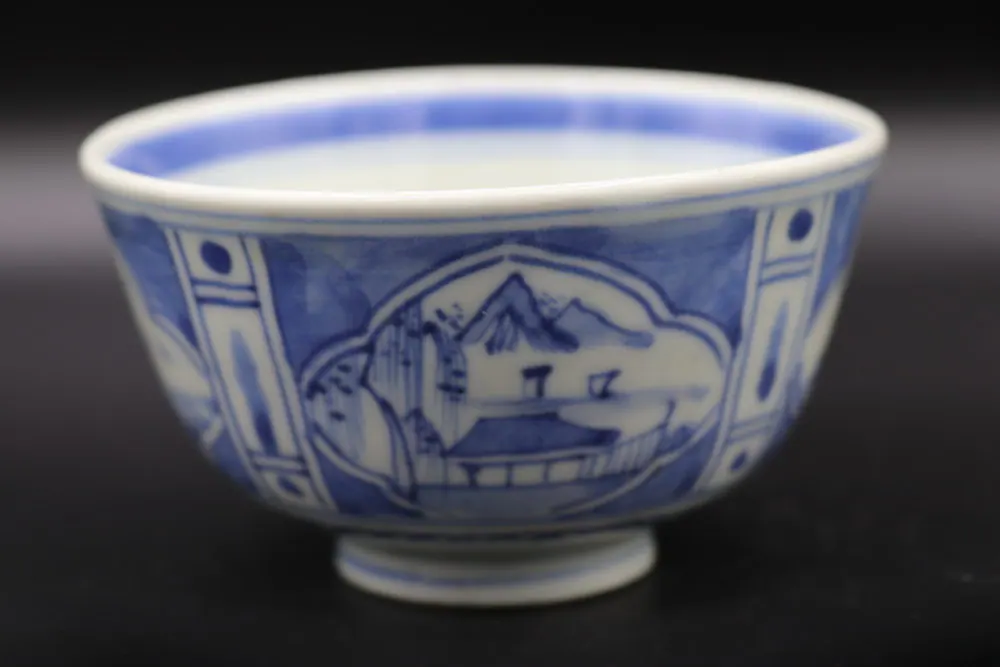 Front view of the bowl showing the landscape cartouche with mountain peaks, water and a pavilion