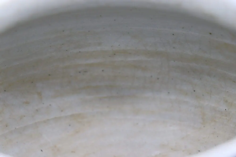 Close-up of the jar's interior neck showing concentric throwing ridges