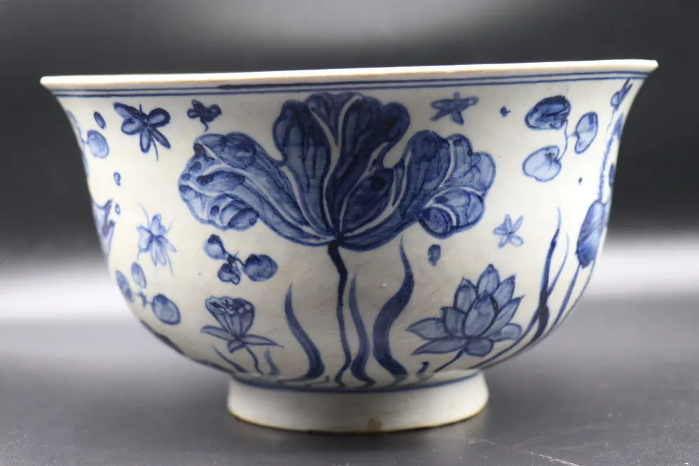 Exterior view of the bowl showing a lotus flower, lily pads, and a dragonfly