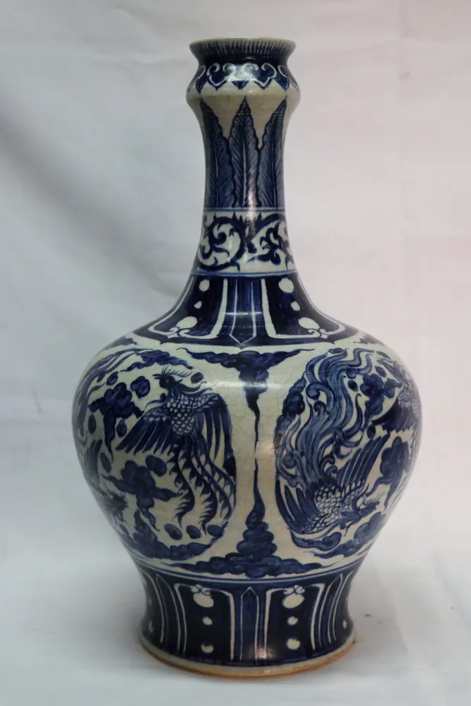 Front view of the blue and white vase showing paired phoenix roundels on a crackled body