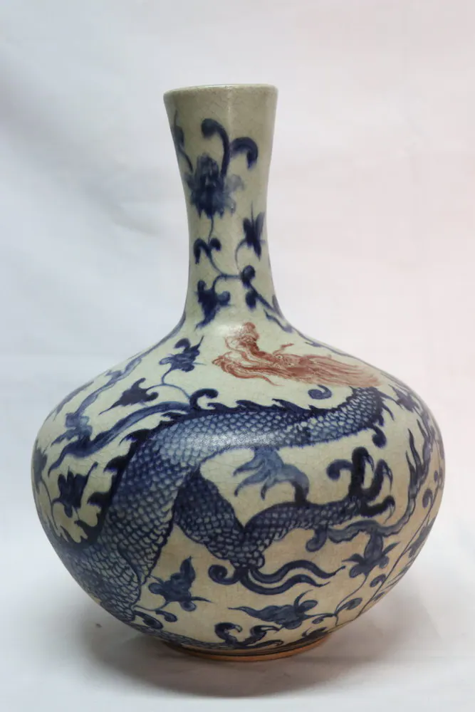 Front view highlighting the dragon's reddish head and mane above its scaled coiled body