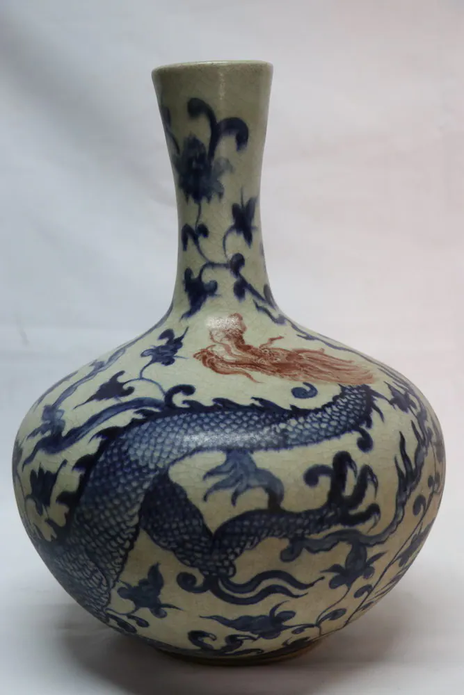 Bottle-form vase with a three-clawed dragon coiling around an ivory-glazed body beneath a scrolling neck