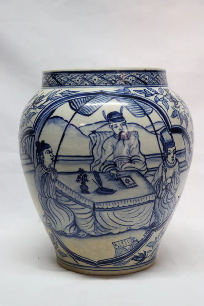 Baluster jar with a scholar and two attendants seated at a table within a floral cartouche