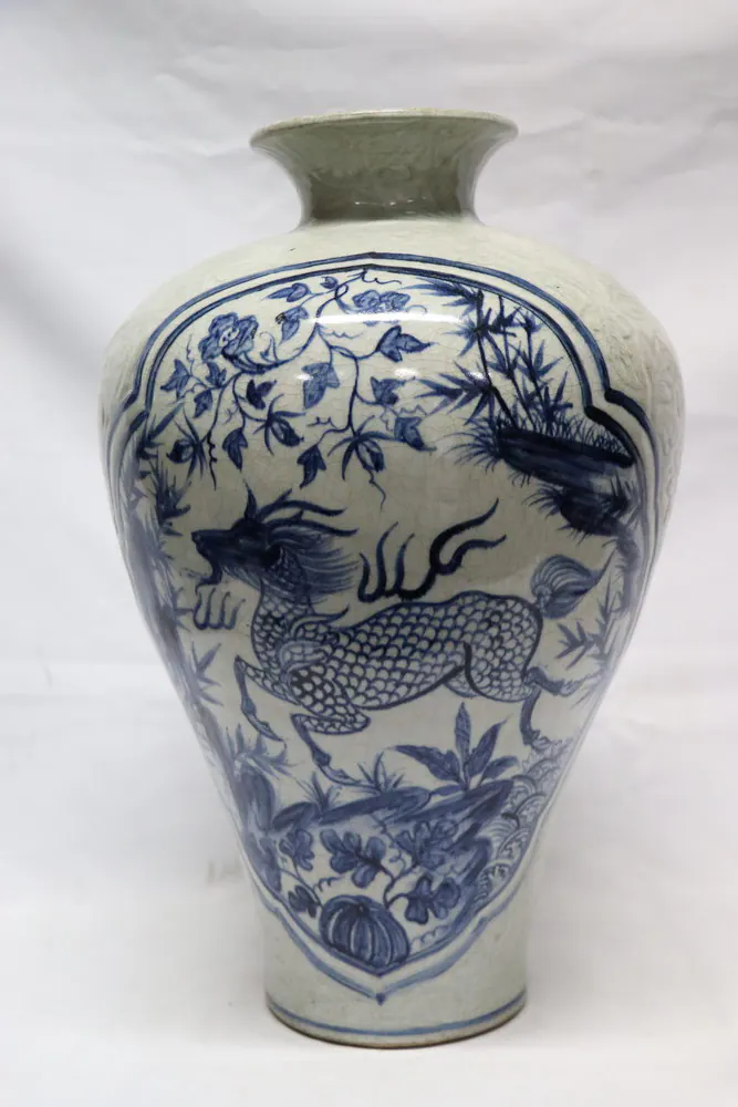 Front view of a meiping vase with a horned qilin in a cartouche below a floral spray, celadon-toned glaze