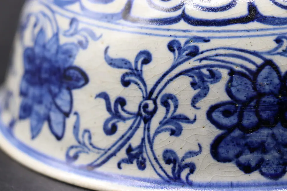 Close-up of the rim's ruyi lappet border above a lotus flower and scrolling tendrils