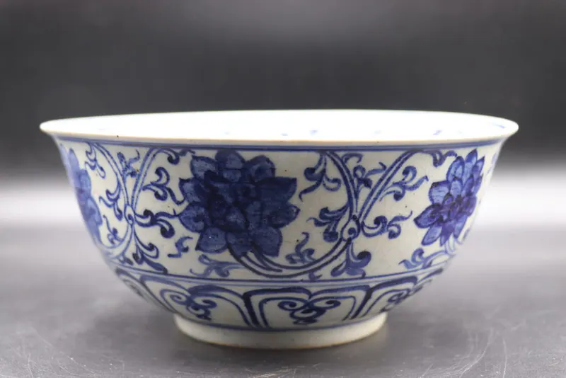 Blue and white bowl, side view, with lotus scrollwork and a ruyi lappet border at the rim