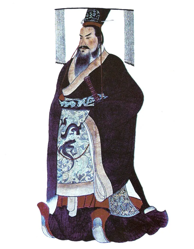 留须君主身穿深色长袍、头戴垂穗冠冕的画像，蔽膝上绘有龙