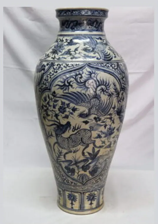 Front view of a tall blue and white vase with a qilin and phoenix in a lobed panel