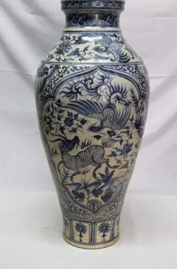 Front view of a tall blue and white vase with a qilin and phoenix in a lobed panel