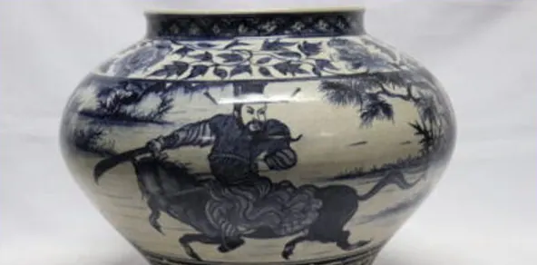 Blue and white jar painted with a mounted warrior brandishing a sword below a leafy band