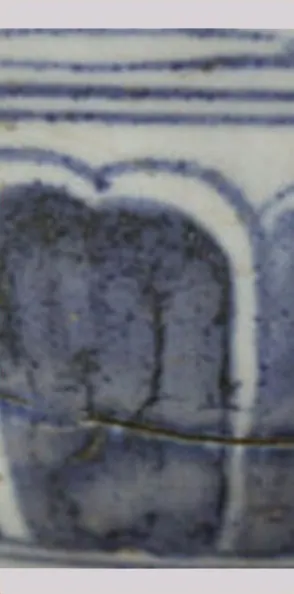 Close-up of blue-painted petal panels and bands on a crackled glaze, with a fine hairline crack