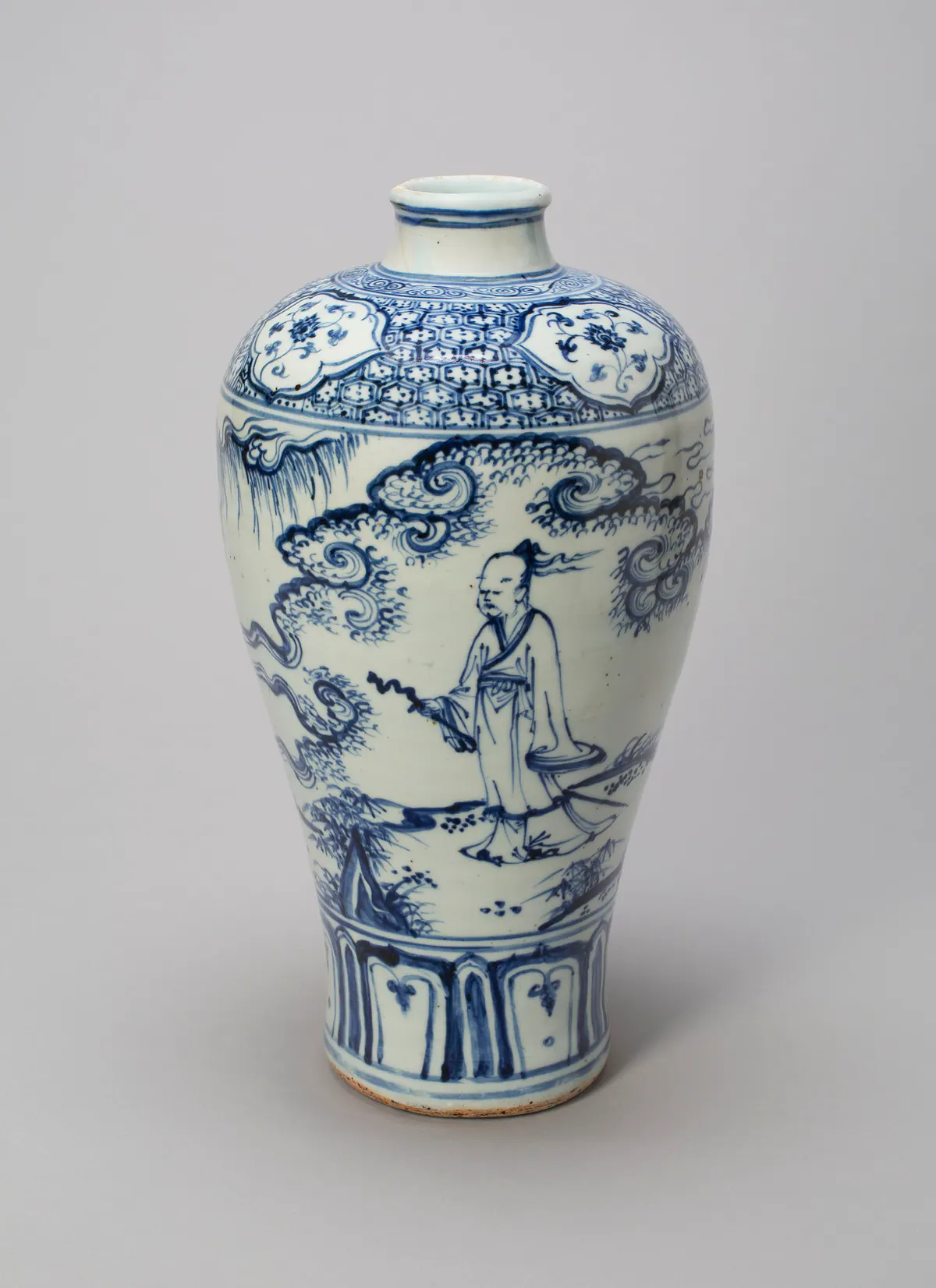 A tall blue and white meiping vase painted with a robed scholar walking among swirling clouds and rocks, below a shoulder band of hexagon diaper and floral panels.