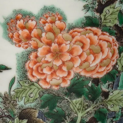 Detail of a Kangxi famille verte vase, about 8 cm across: an iron-red peony and green leaves painted in flat enamel washes inside drawn outlines on white porcelain
