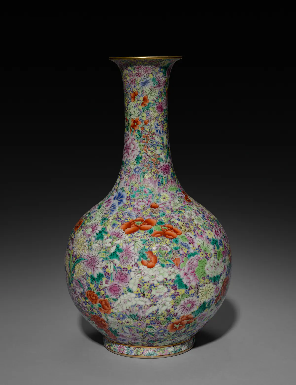 A Jiaqing porcelain bottle vase covered all over in a millefleurs pattern of densely packed shaded flowers in pink, iron red, yellow, green and blue, with a gilt mouth.