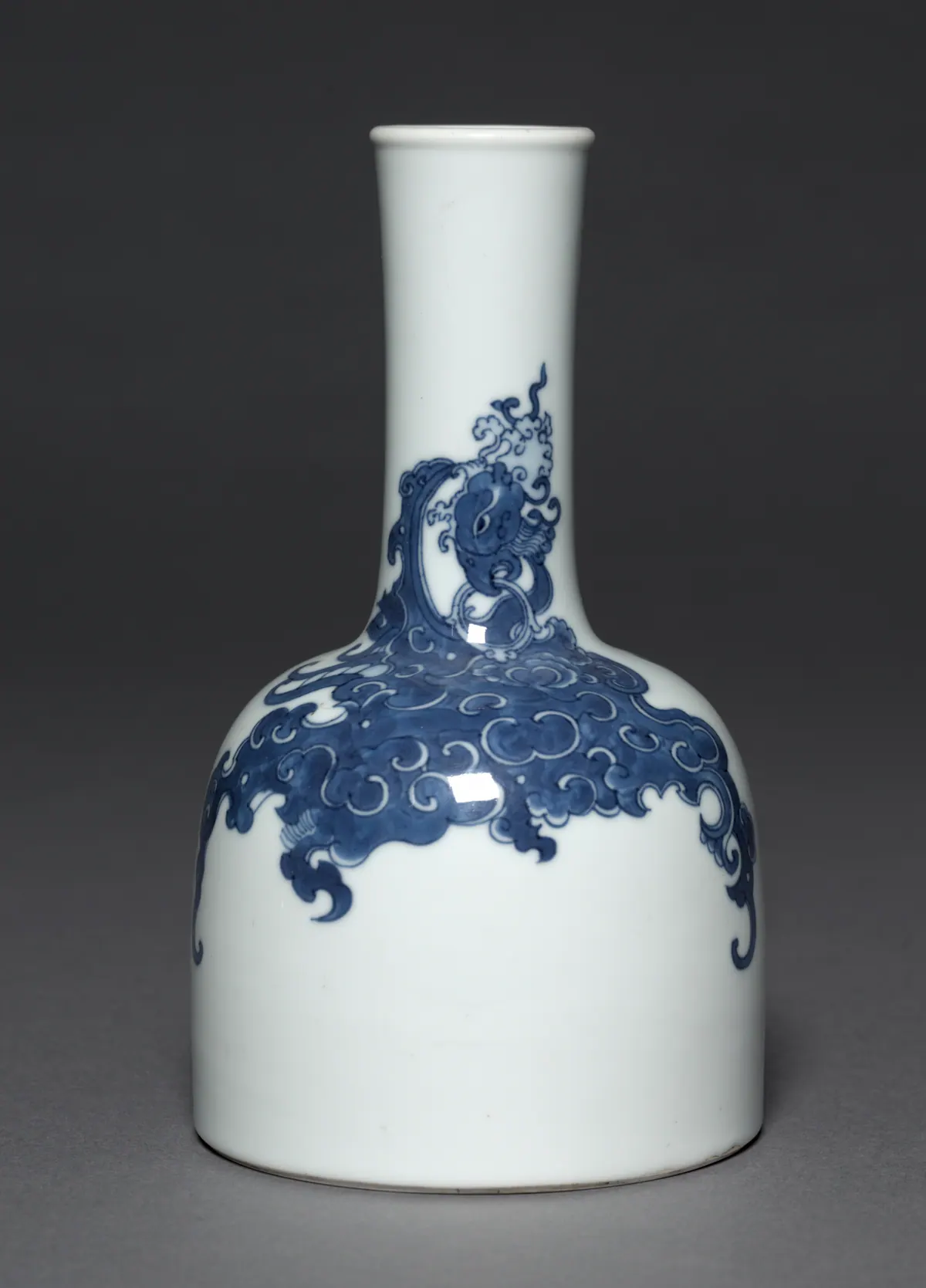 Kangxi blue and white mallet-shaped bottle with a tall narrow neck, painted in deep underglaze cobalt with a phoenix among swirling clouds on a white body
