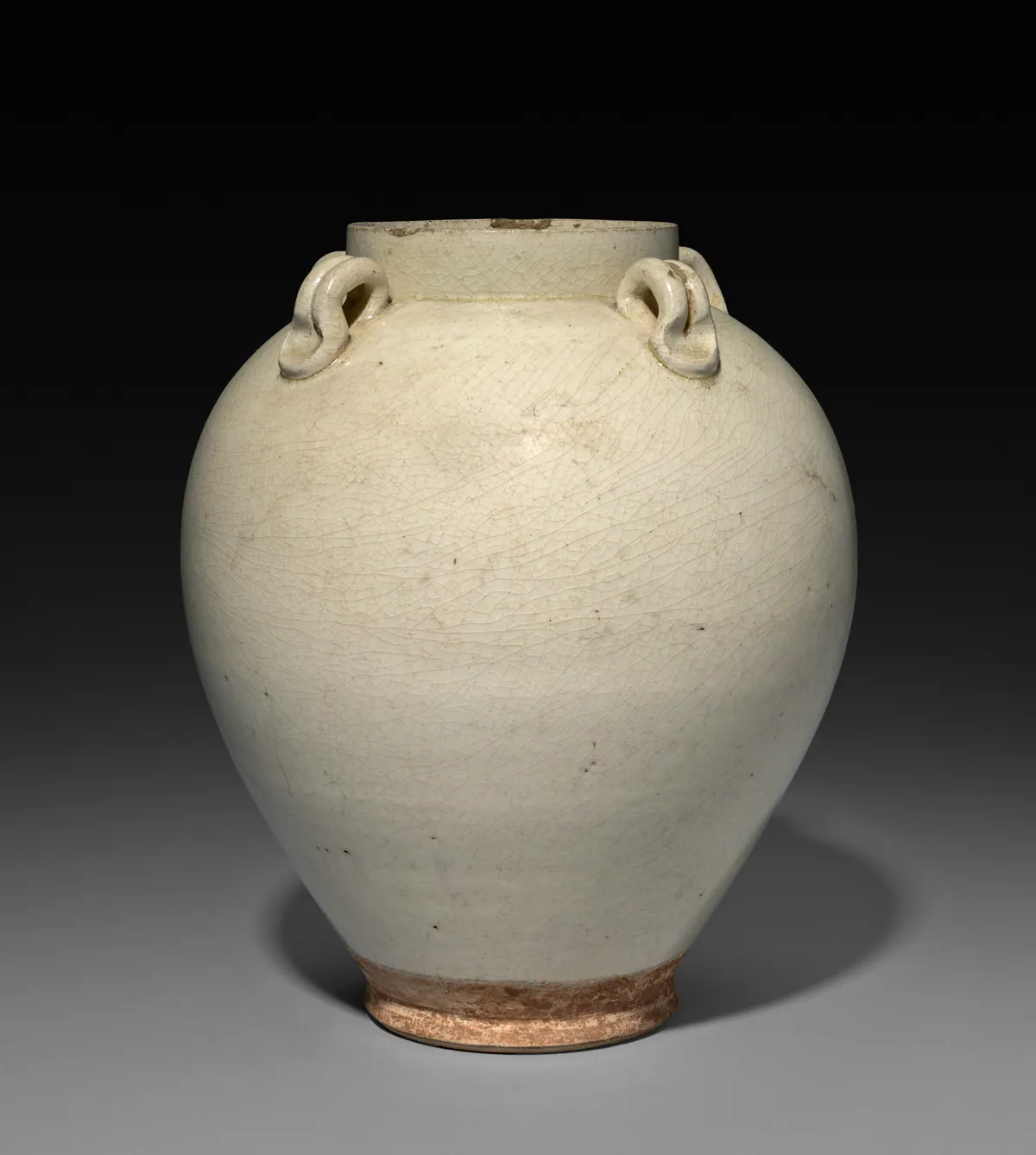 An ovoid stoneware jar with four looped handles on the shoulder, covered in a pale, finely crackled greyish-white glaze that stops above the foot.