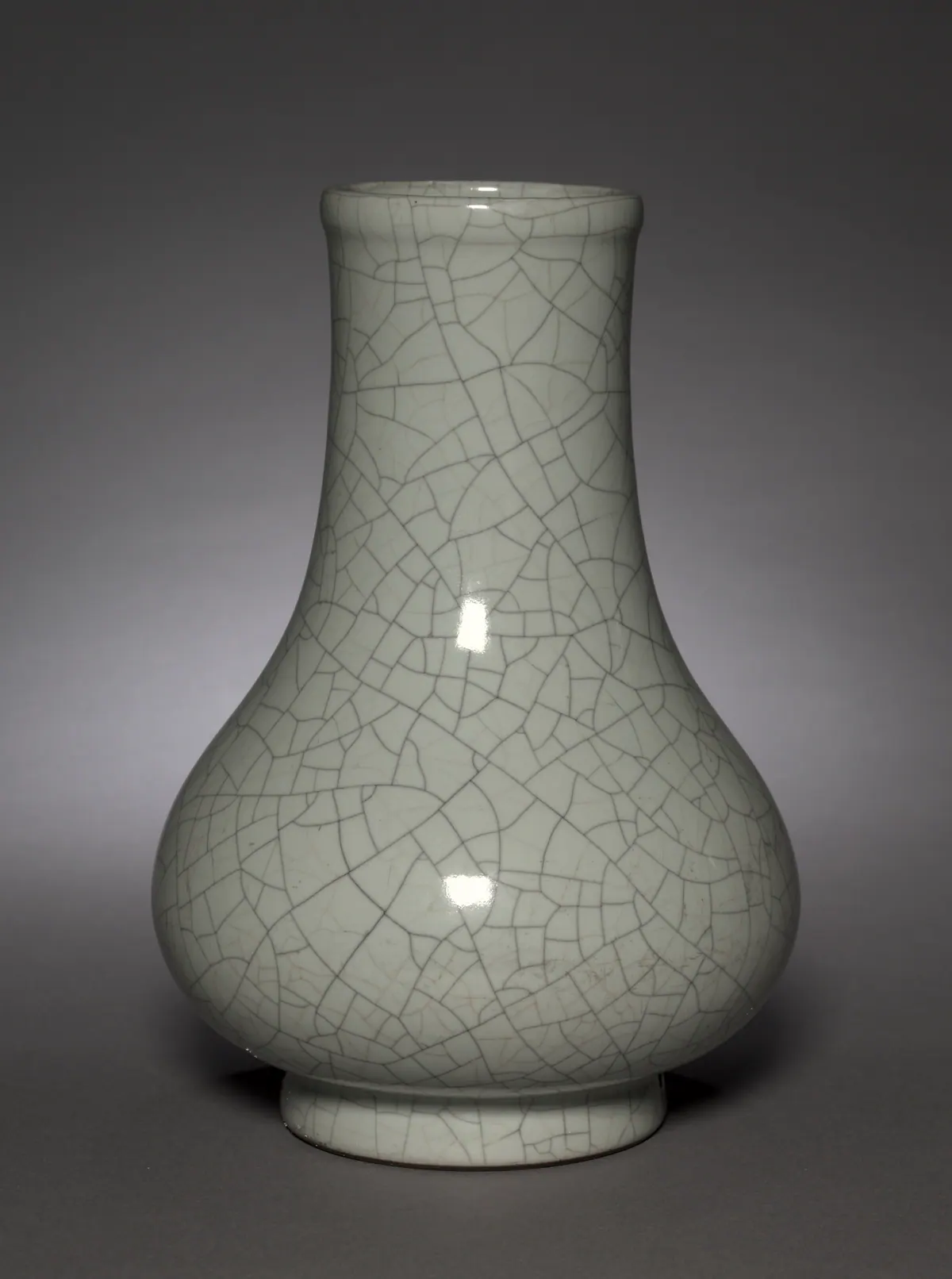 Yongzheng pear-shaped porcelain vase covered in a pale grey-green monochrome glaze with a network of dark crackle, made in imitation of Song dynasty Guan ware