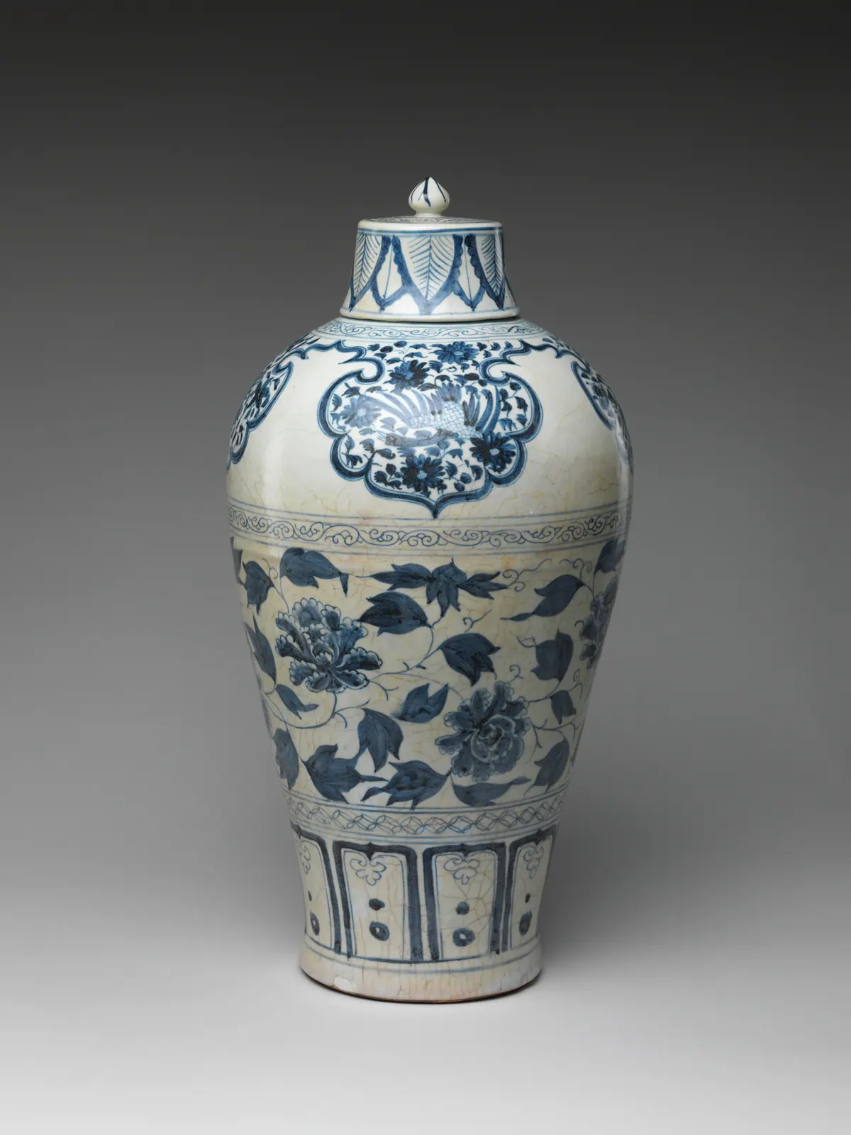 A tall Yuan blue and white meiping with its cover, painted with a bold peony scroll on the body, a bird in lobed panels on the shoulder and petal panels above the foot.